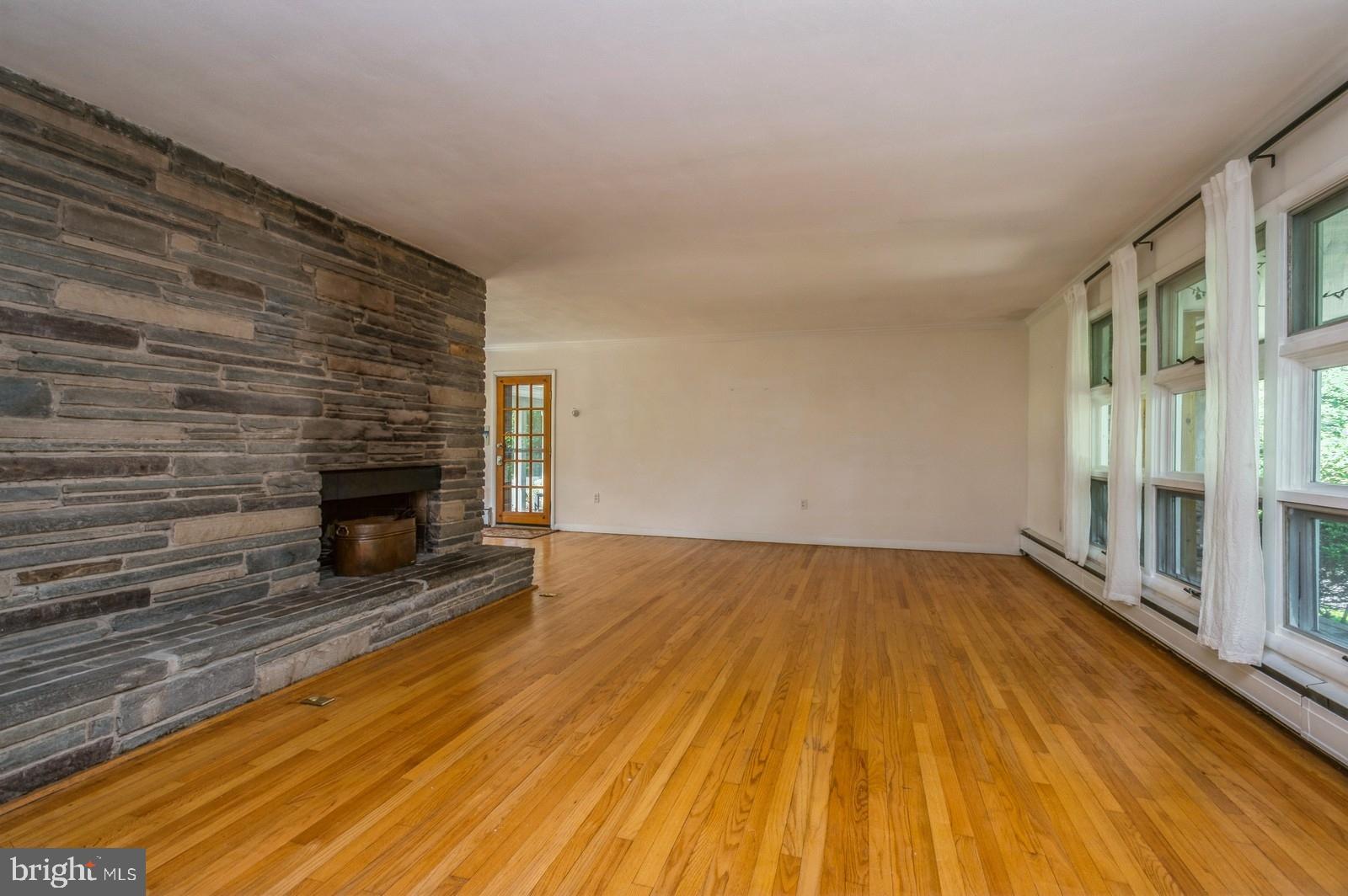 536 Rosedale Road Princeton, NJ 08540 - Photo 4 of 34 a view of empty room with wooden floor and fireplace