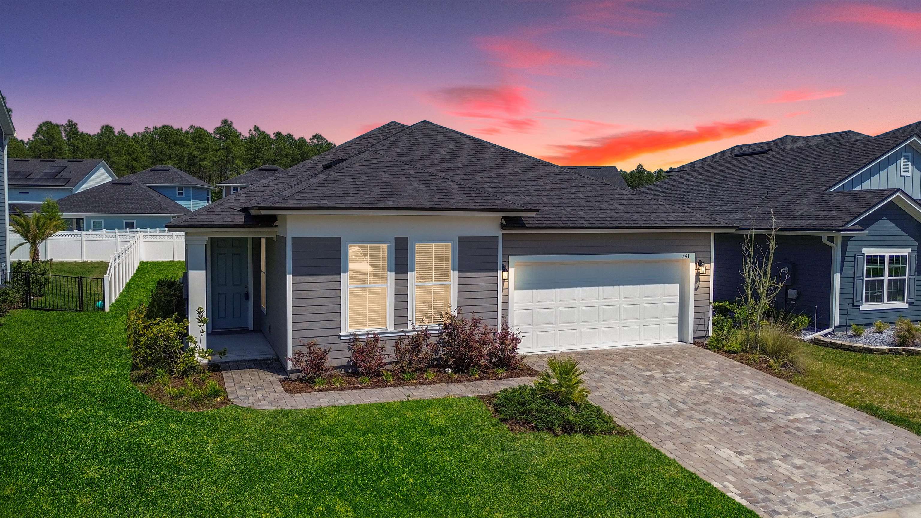 a front view of a house with a yard and garage