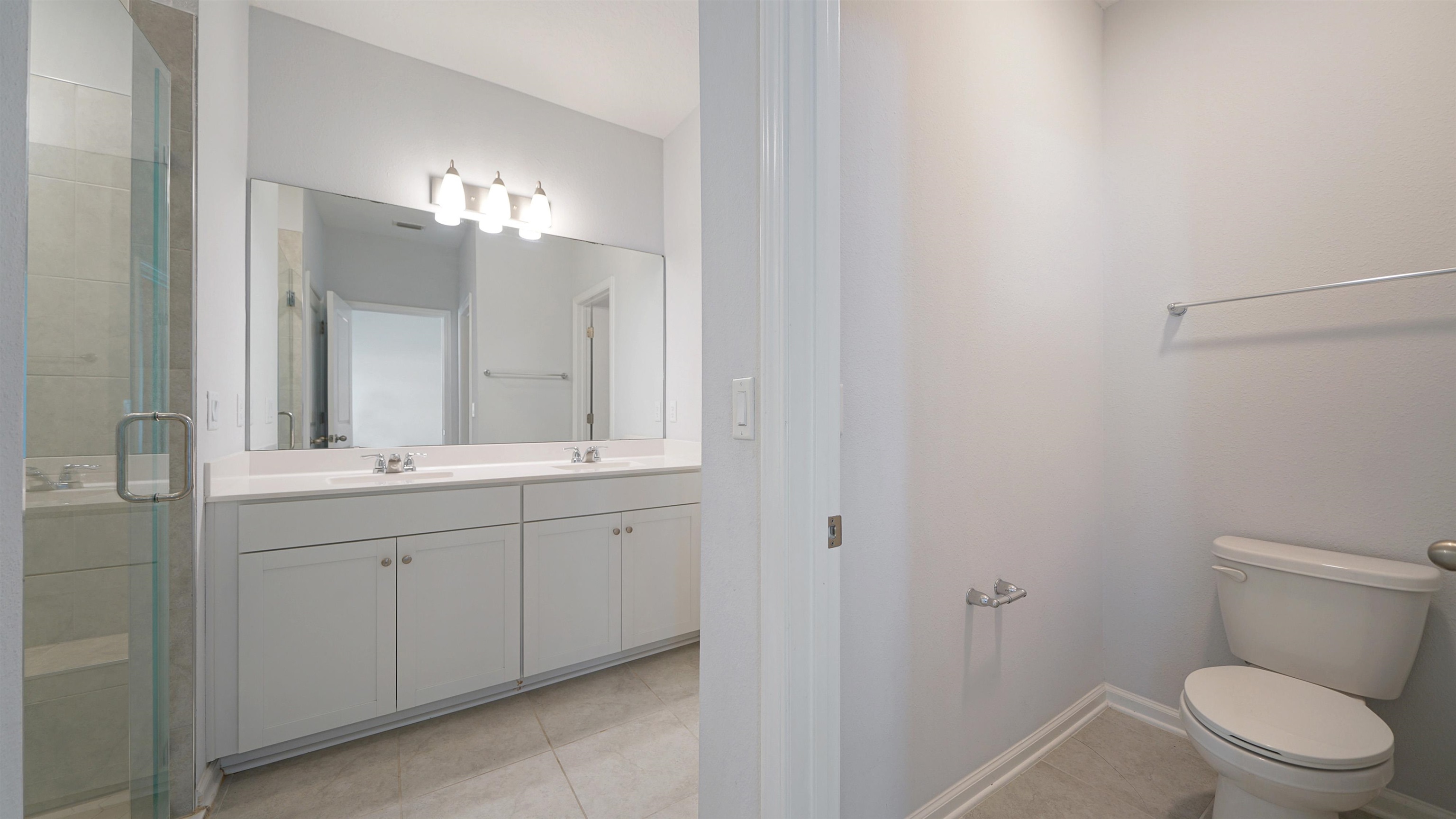 443 Watervale Drive St. Augustine, FL 32092 - Photo 12 of 39 a bathroom with a toilet a sink and mirror