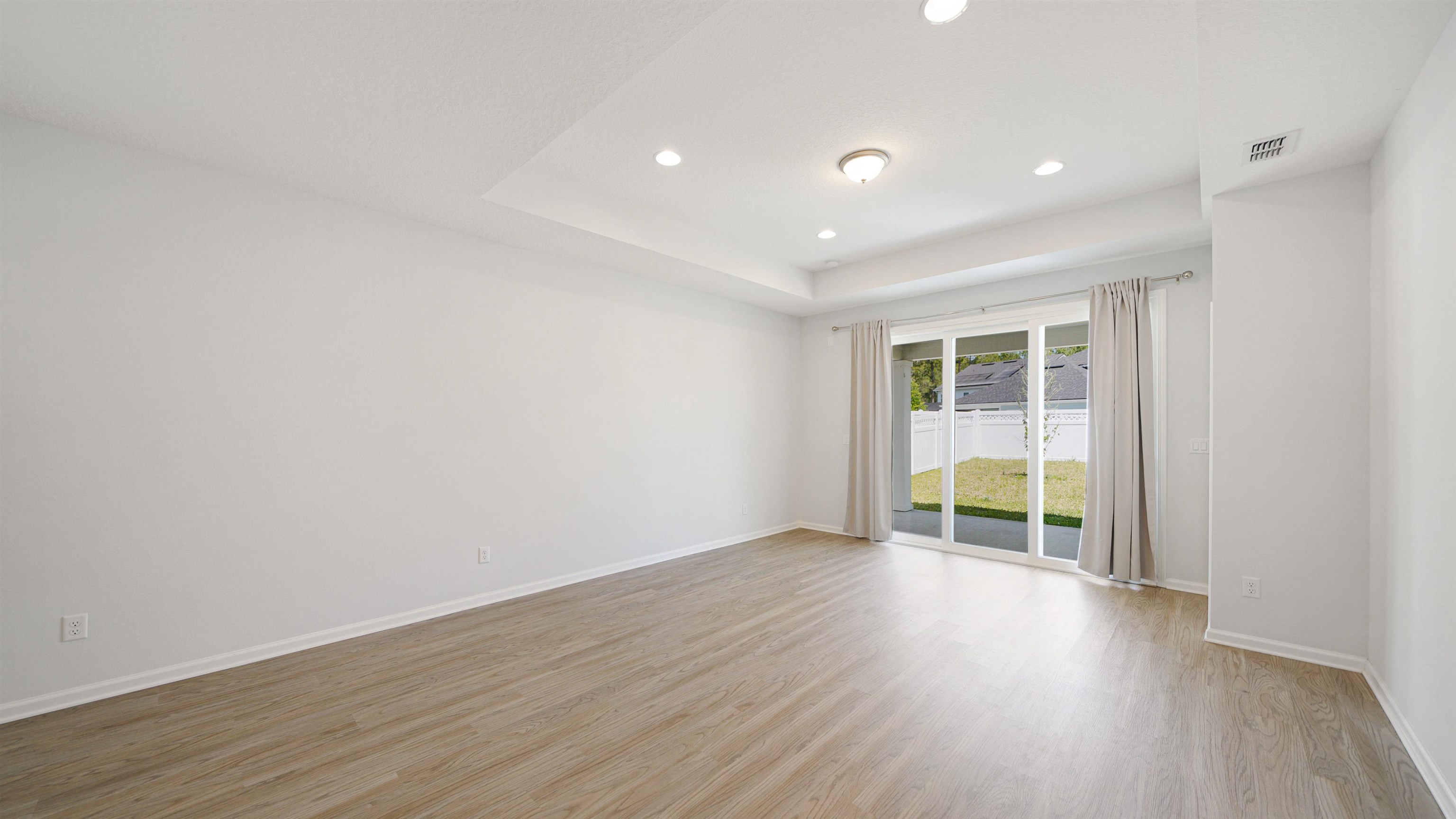 443 Watervale Drive St. Augustine, FL 32092 - Photo 4 of 39 an empty room with wooden floor and windows
