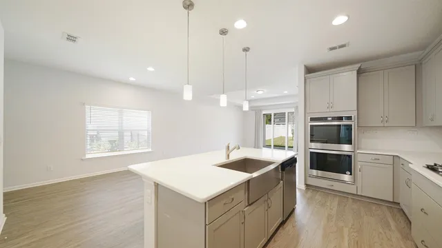a kitchen with a sink stove and microwave