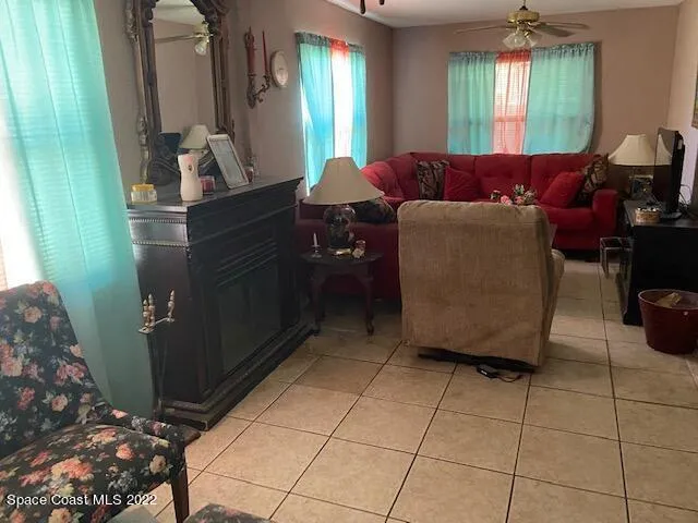 a living room with furniture and a mirror