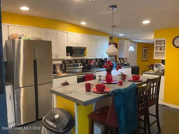 a kitchen that has a table and chairs in it