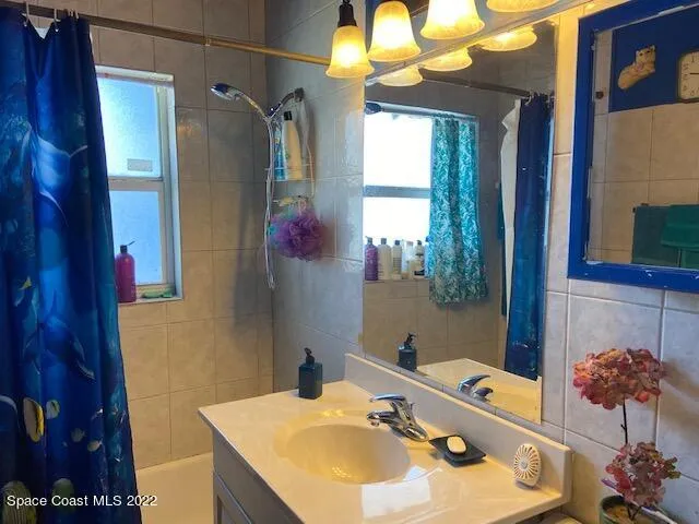 a bathroom with a sink vanity and a mirror
