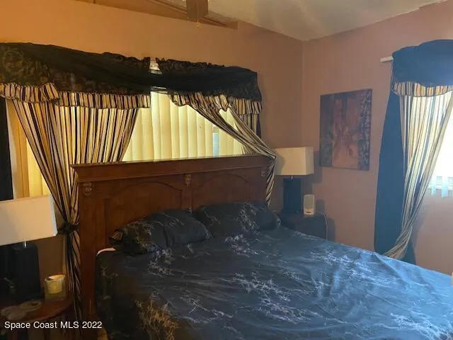 a view of a backyard with wooden fence