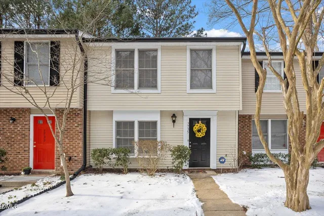 a front view of a house with glass windows and couch