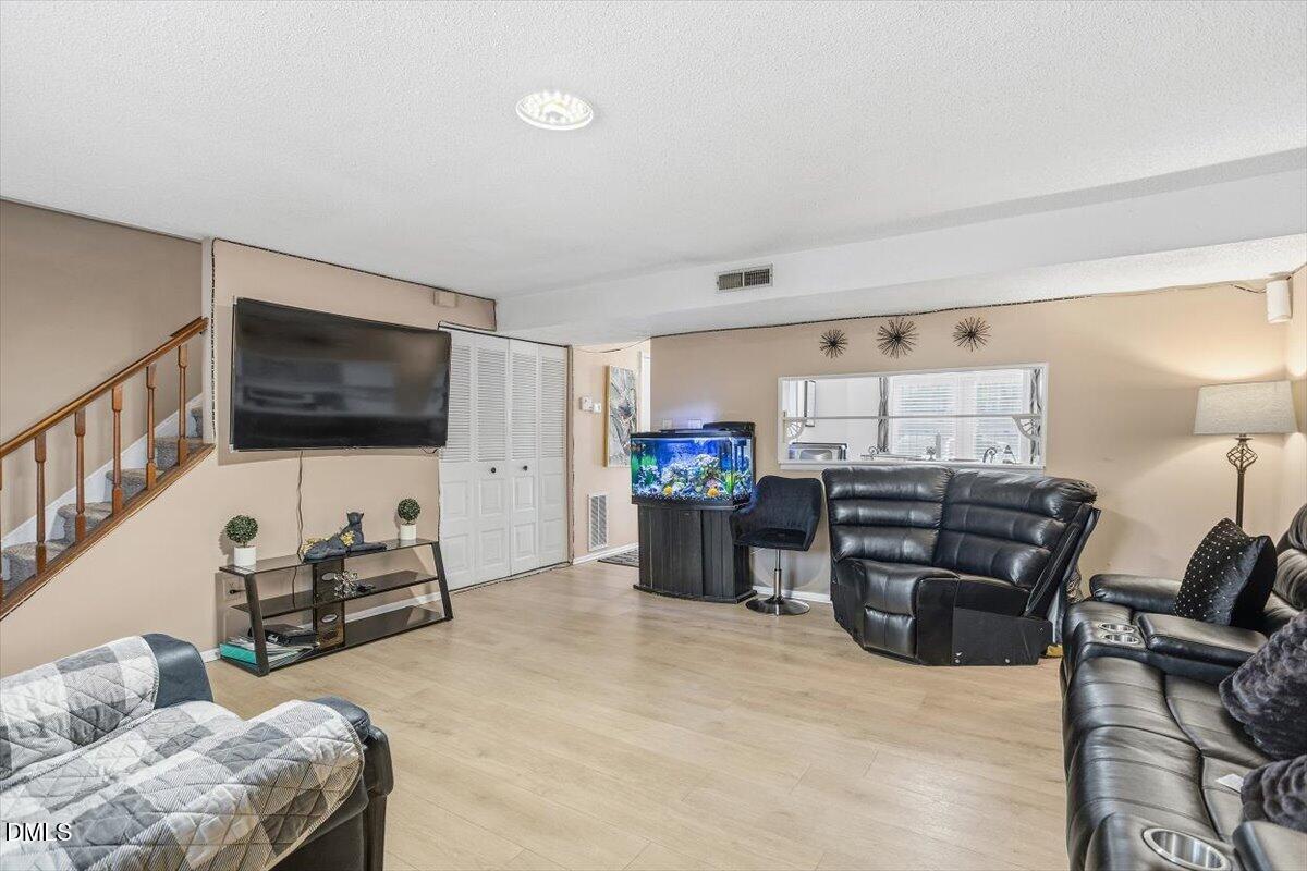 7735 Sandra Lane Raleigh, NC 27615 - Photo 12 of 20 a living room with furniture and a flat screen tv