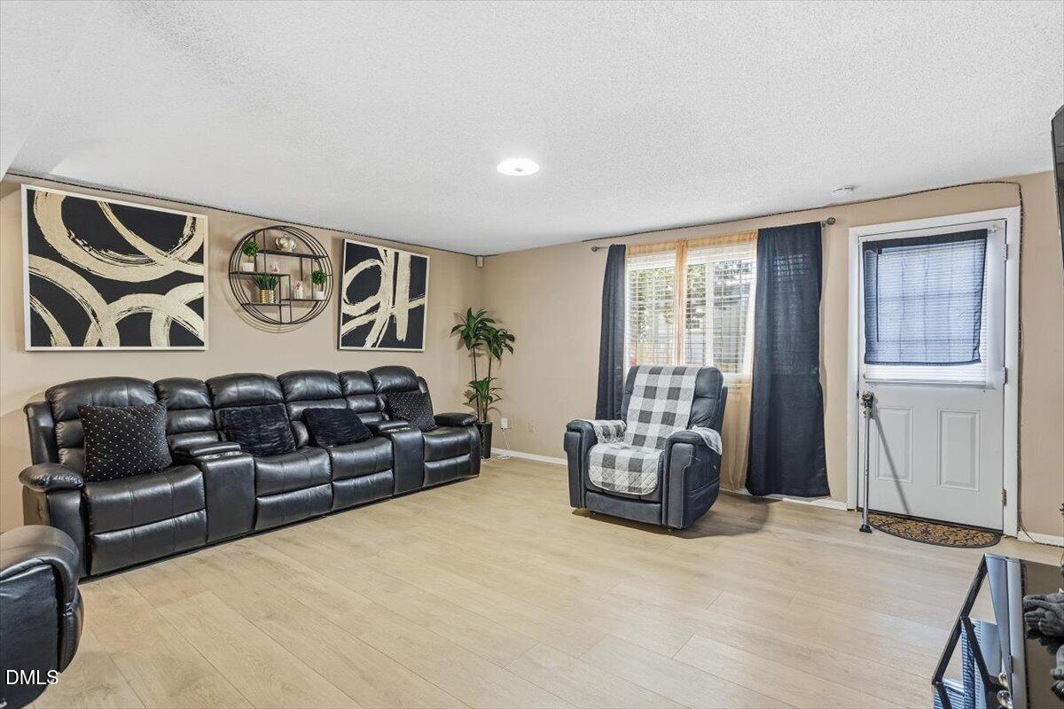 7735 Sandra Lane Raleigh, NC 27615 - Photo 13 of 20 a living room with furniture window and couch
