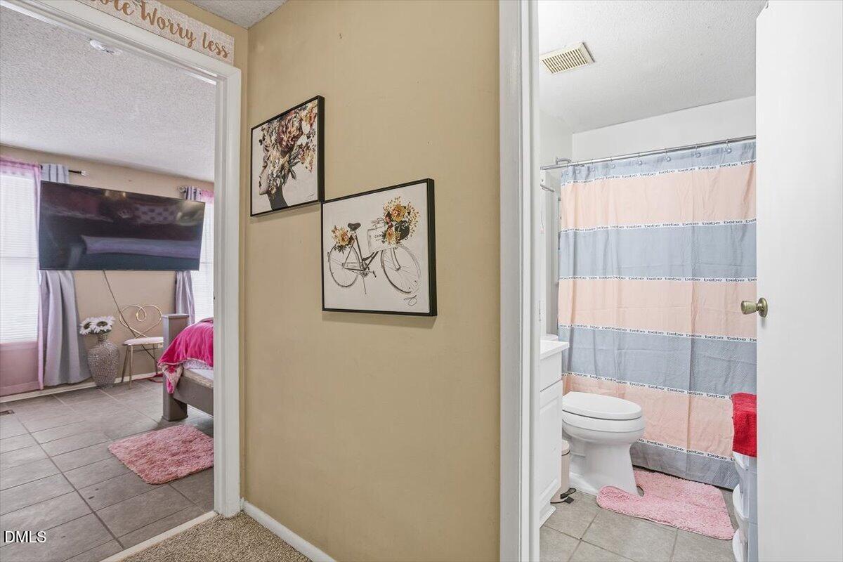 7735 Sandra Lane Raleigh, NC 27615 - Photo 14 of 20 a bathroom with a sink toilet and shower