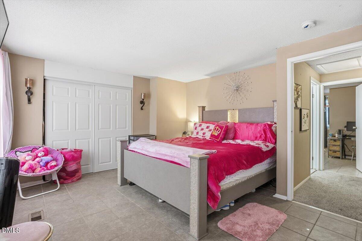 7735 Sandra Lane Raleigh, NC 27615 - Photo 5 of 20 a bedroom with a bed and a table