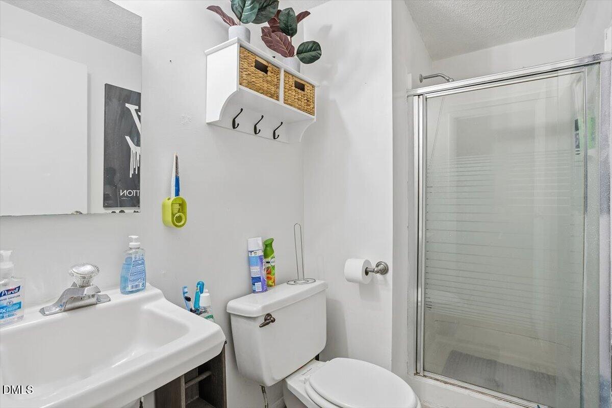 7735 Sandra Lane Raleigh, NC 27615 - Photo 8 of 20 a bathroom with a sink toilet and shower