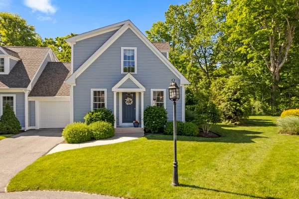 a front view of house with outdoor space and garden