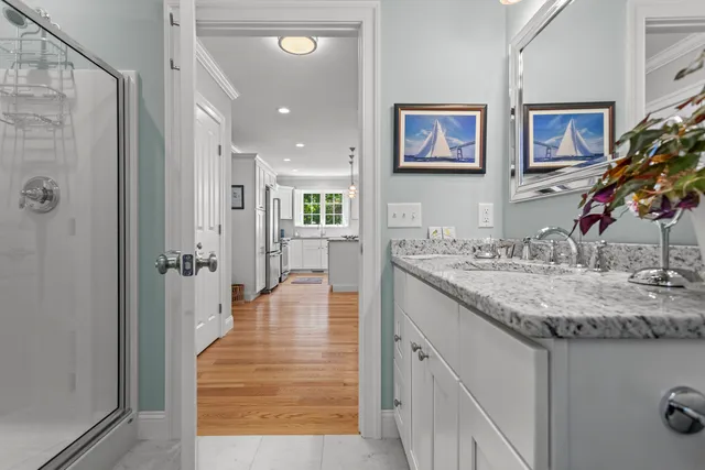 a bathroom with a granite countertop sink shower and a mirror