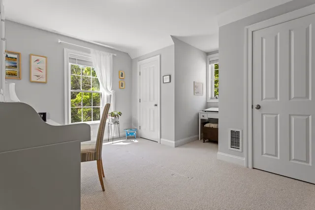 a view of a livingroom with furniture and a window