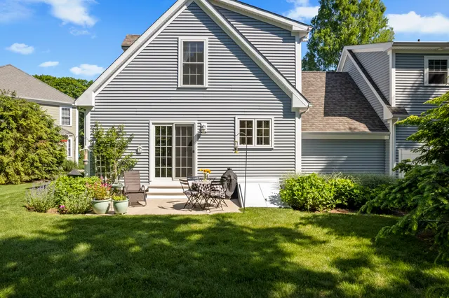 a front view of house with a garden and patio