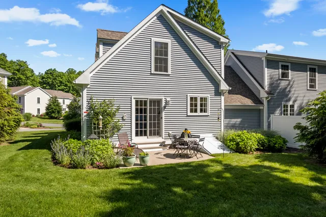 a front view of house with yard and outdoor seating