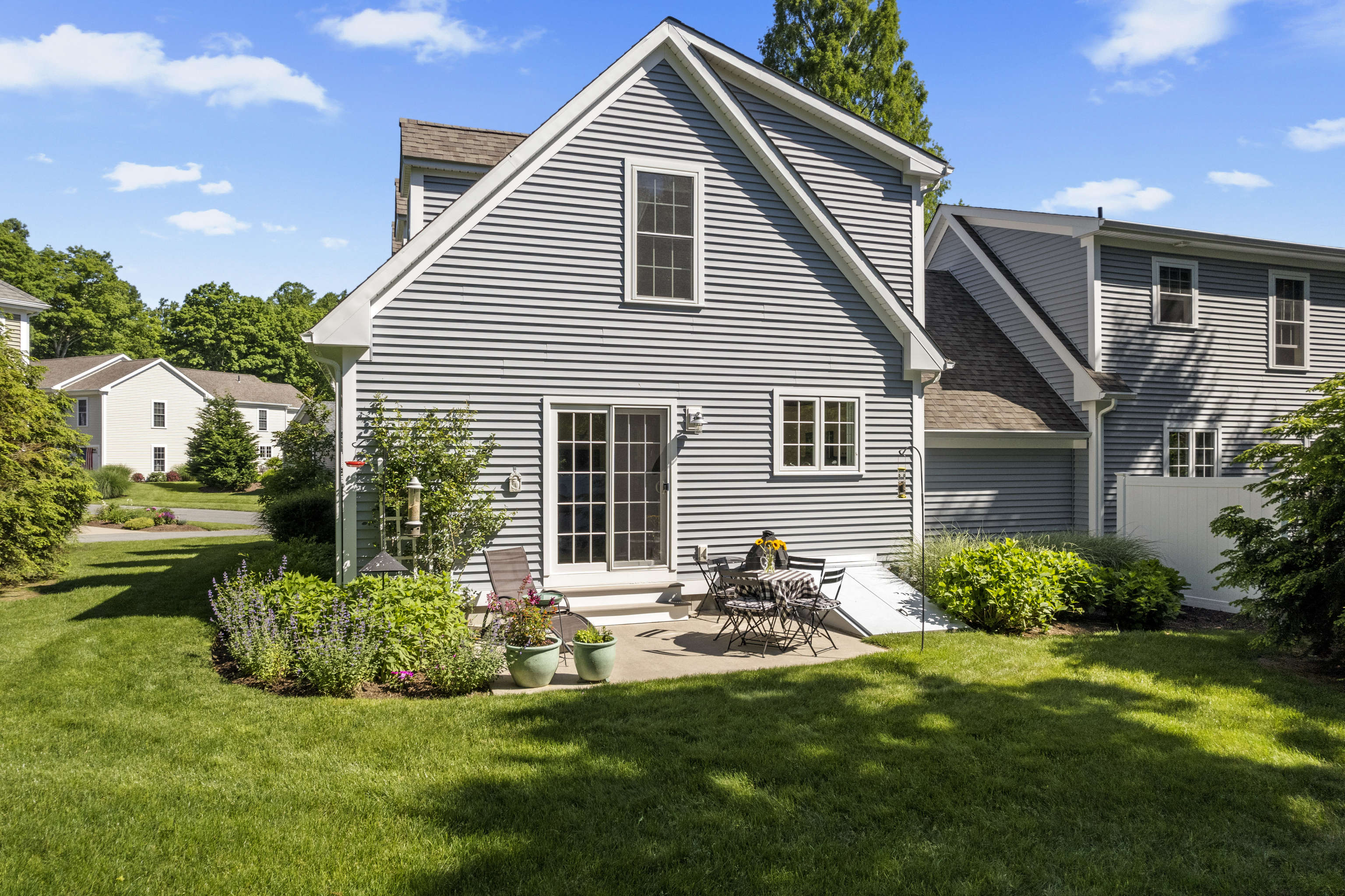 951 Old Clinton Road, Unit 15 Westbrook, CT 06498 - Photo 26 of 30 a front view of house with yard and outdoor seating