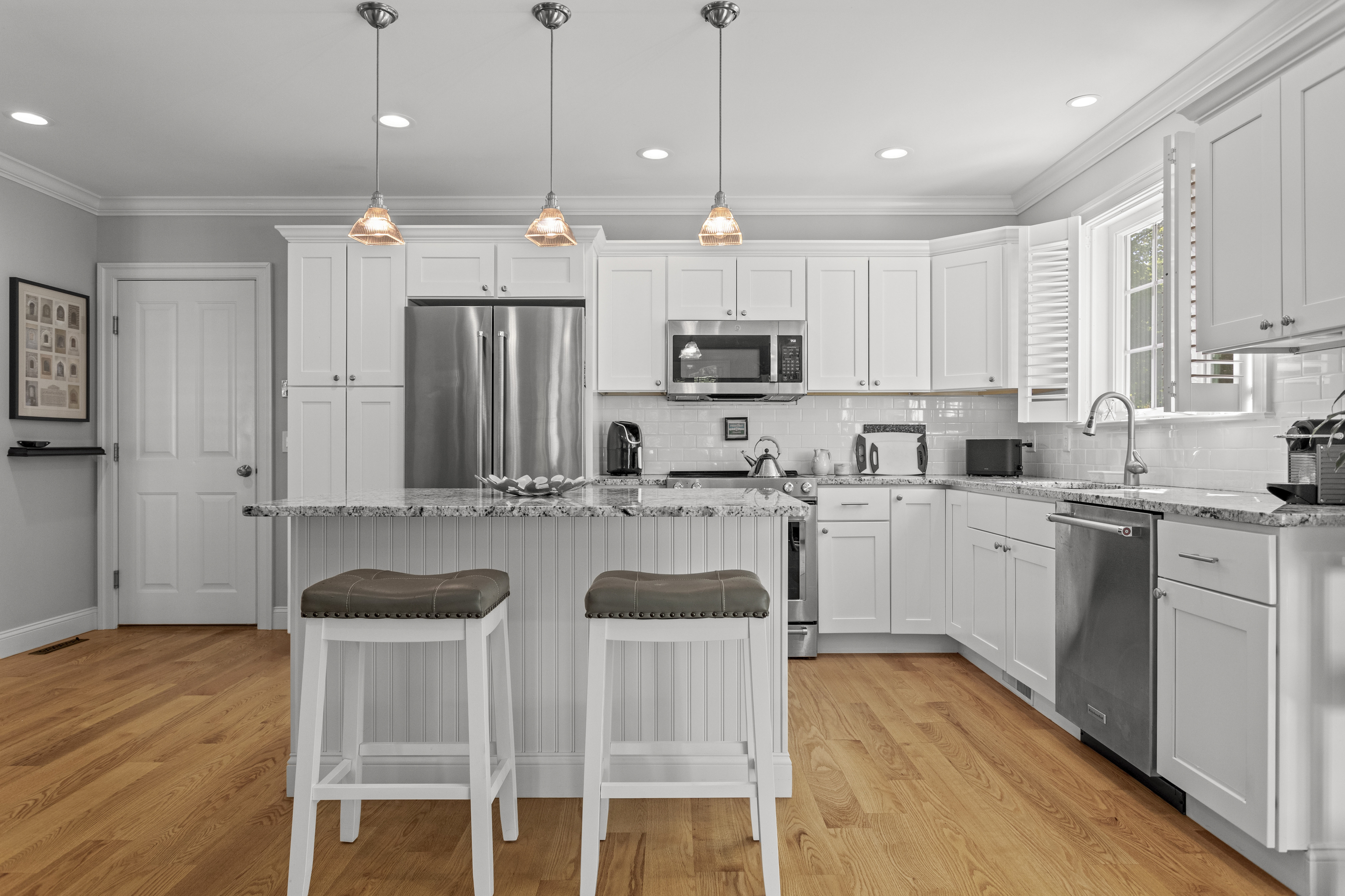 951 Old Clinton Road, Unit 15 Westbrook, CT 06498 - Photo 6 of 30 a kitchen with kitchen island granite countertop a sink a center island and cabinets