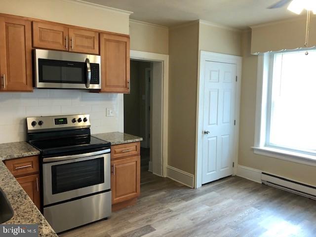 102 West Broad Street, Unit 1 Souderton, PA 18964 - Photo 11 of 20 a kitchen with a stove and a microwave