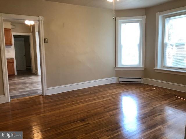 102 West Broad Street, Unit 1 Souderton, PA 18964 - Photo 6 of 20 an empty room with wooden floor and windows
