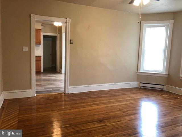 102 West Broad Street, Unit 1 Souderton, PA 18964 - Photo 7 of 20 an empty room with wooden floor and windows