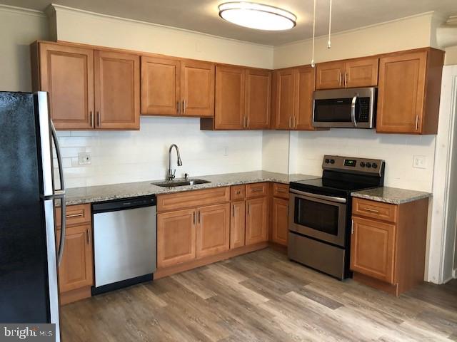 102 West Broad Street, Unit 1 Souderton, PA 18964 - Photo 9 of 20 a kitchen with stainless steel appliances granite countertop a sink a stove a microwave and wooden cabinets