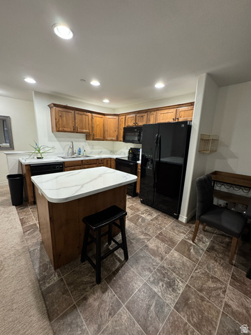 909 South Main Street, Unit F Layton, UT 84041 - Photo 4 of 20 Kitchen featuring a central island with a white marble-look countertop