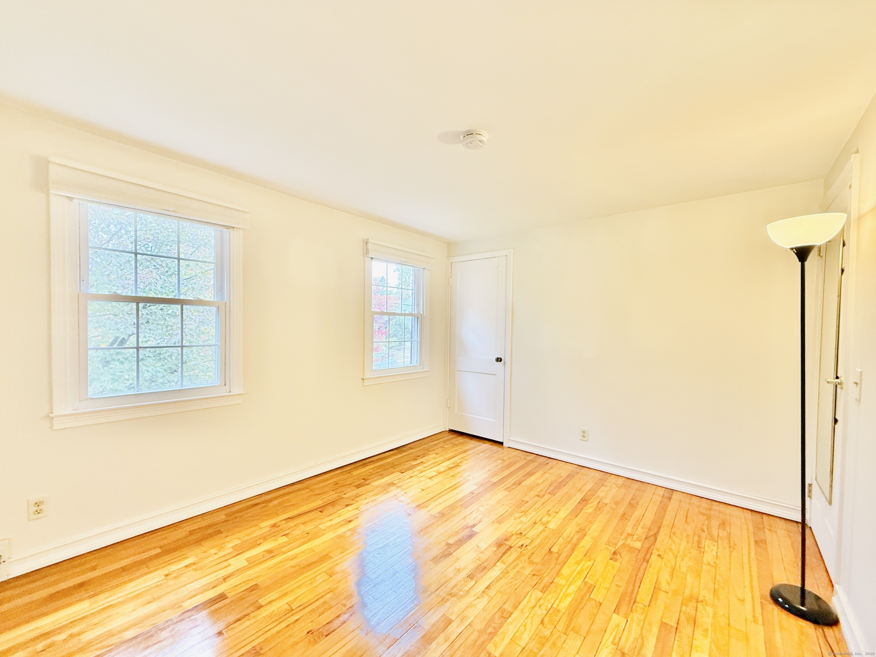 171 Sylvan Knoll Road Stamford, CT 06902 - Photo 11 of 23 a view of an empty room with wooden floor and a window