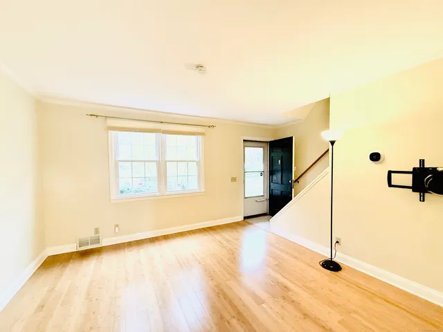a view of a room with wooden floor