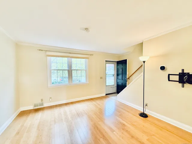 a view of a room with wooden floor and windows