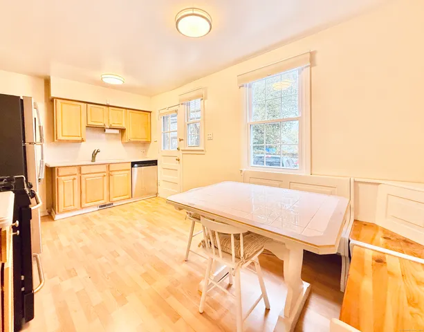 a spacious bedroom with a bed and wooden floor