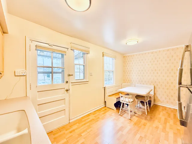 a view of a room with a table and chairs