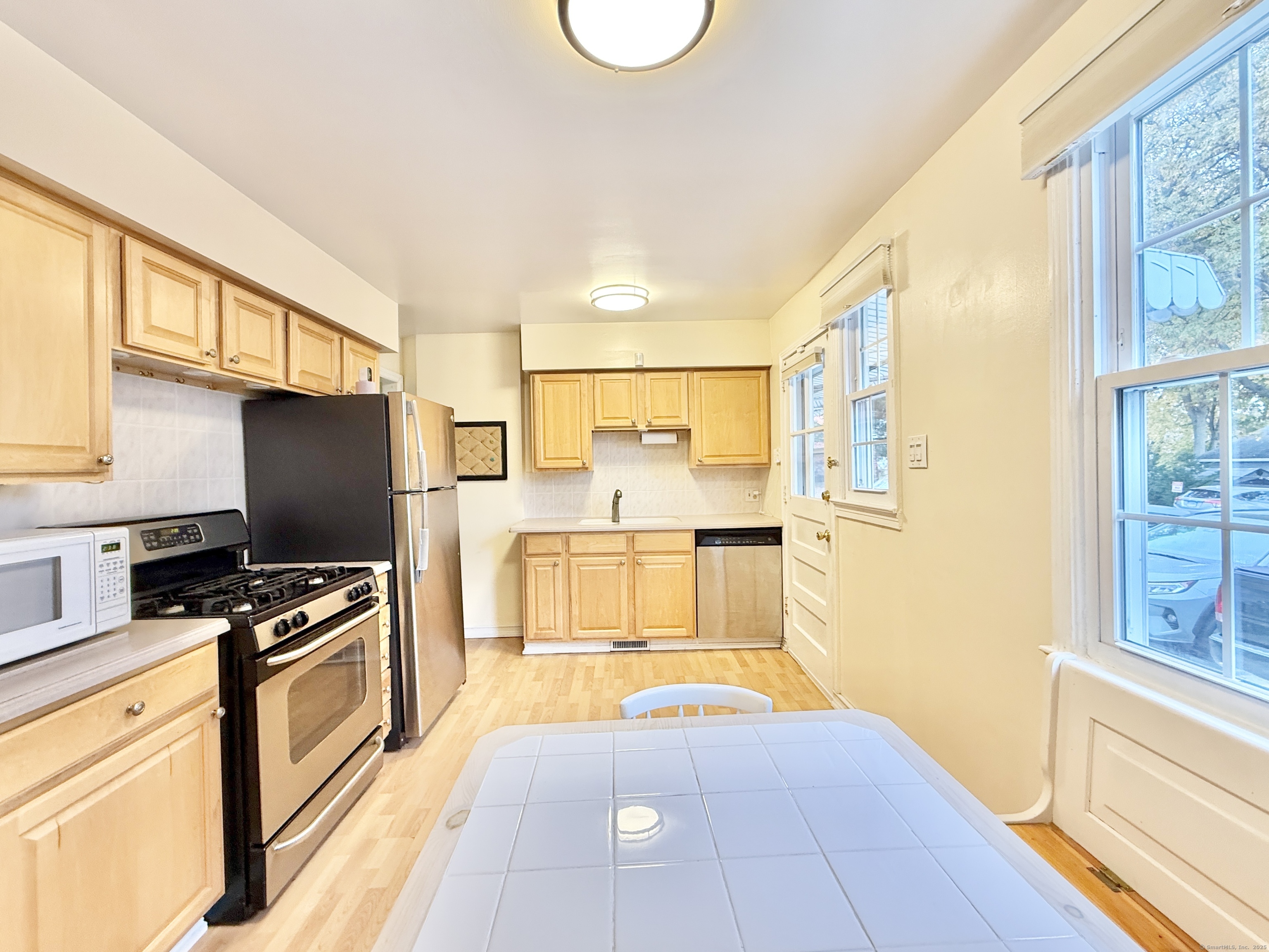 171 Sylvan Knoll Road Stamford, CT 06902 - Photo 9 of 23 a kitchen with stainless steel appliances granite countertop a stove a sink and a refrigerator