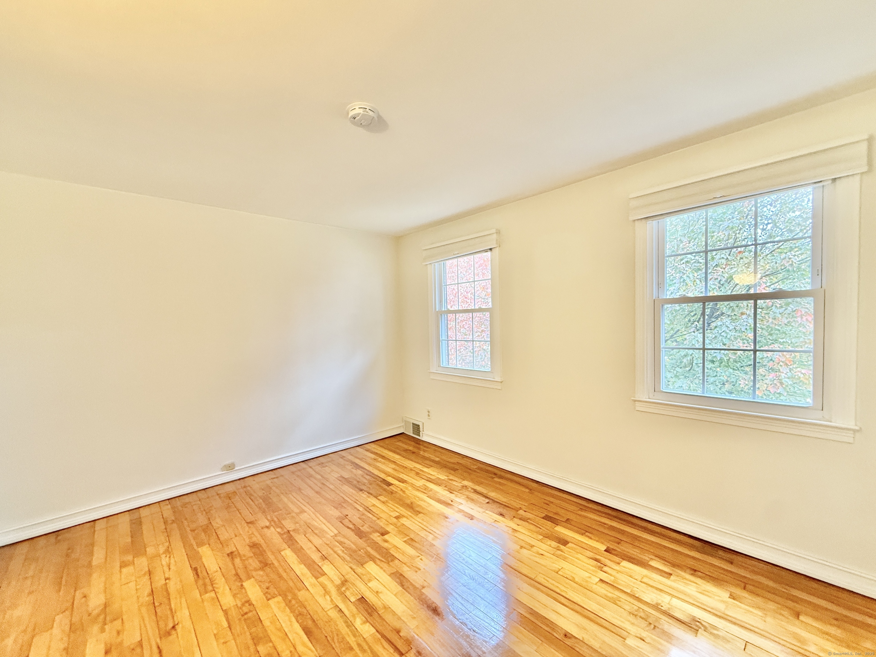 171 Sylvan Knoll Road Stamford, CT 06902 - Photo 10 of 23 a view of an empty room with wooden floor and a window