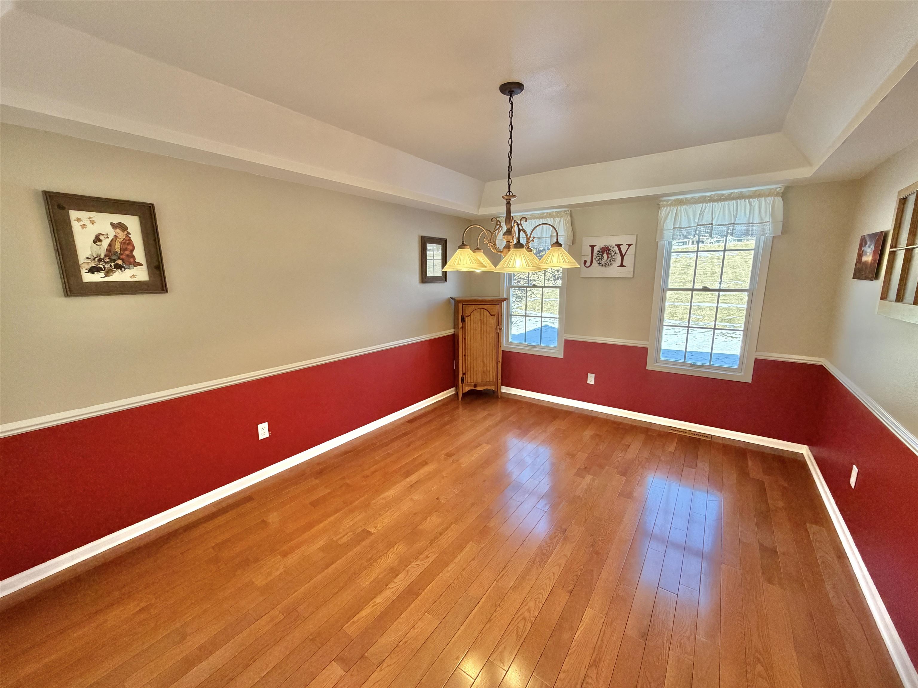 5206 East Hubbard Trail Byron, IL 61010 - Photo 14 of 52 a view of empty room with window and wooden floor