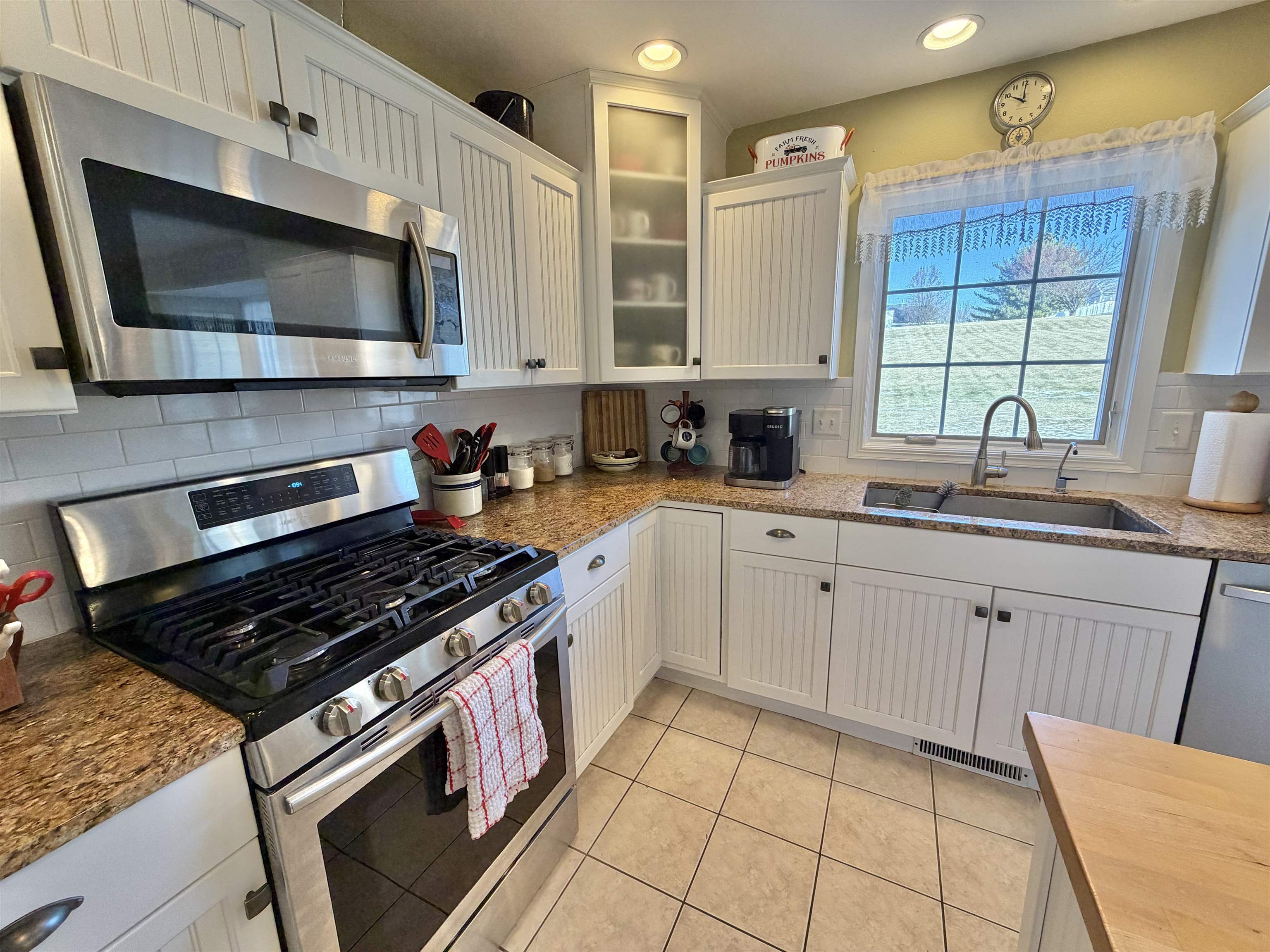 5206 East Hubbard Trail Byron, IL 61010 - Photo 21 of 52 a kitchen with stainless steel appliances a sink dishwasher stove microwave and cabinets