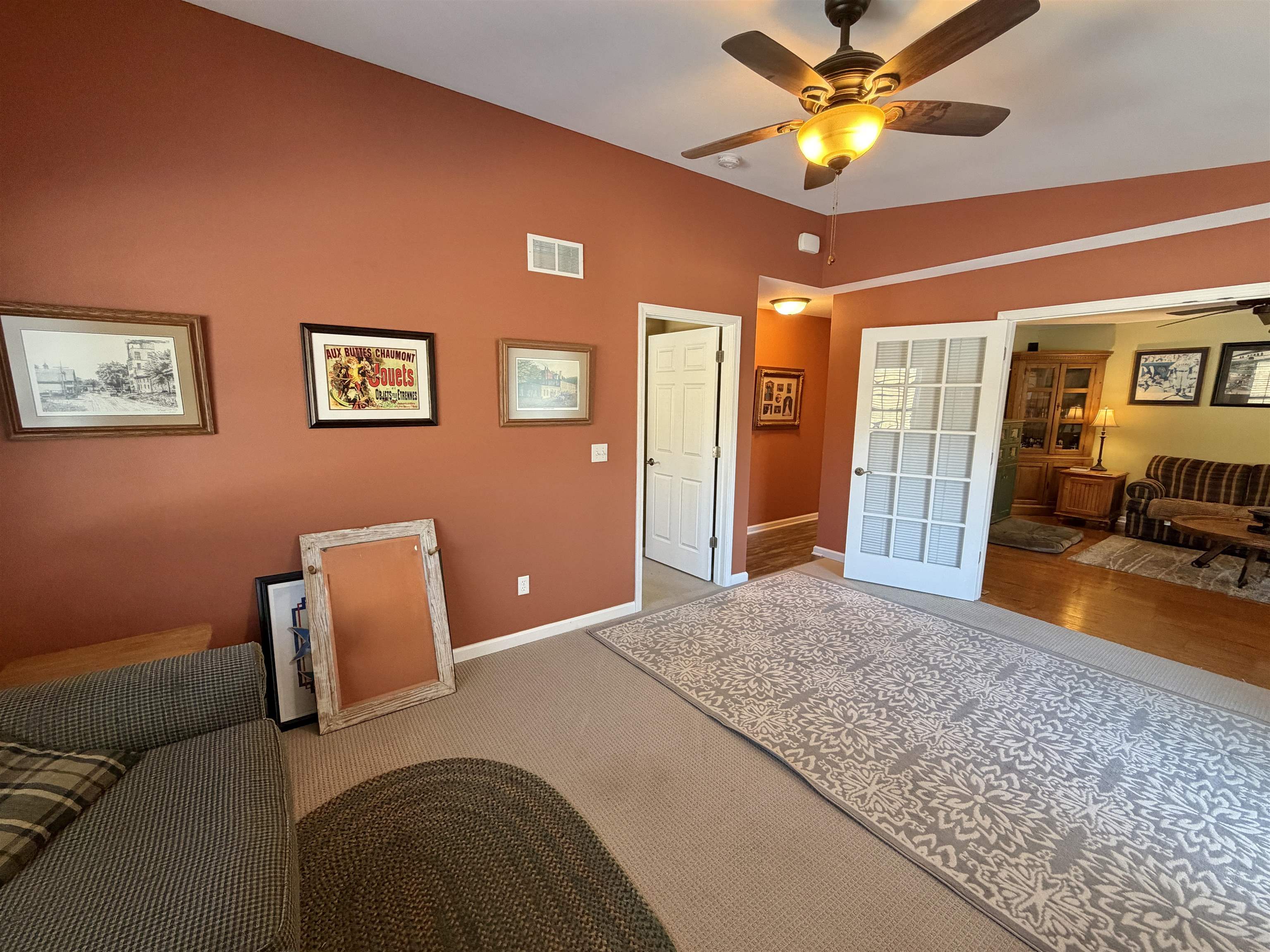 5206 East Hubbard Trail Byron, IL 61010 - Photo 25 of 52 a bedroom with a bed and a chandelier