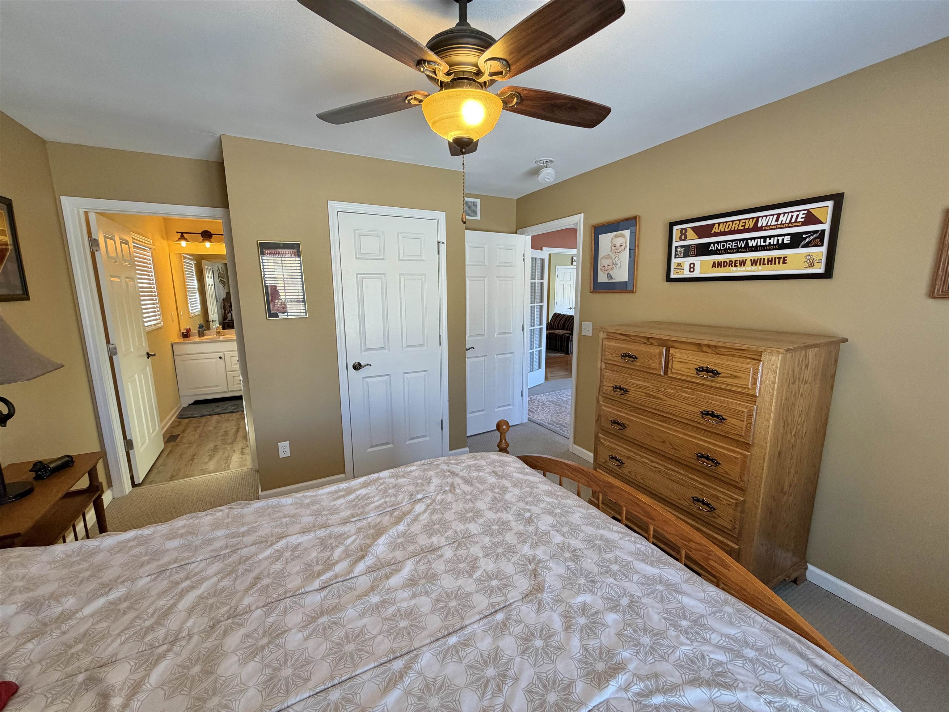 5206 East Hubbard Trail Byron, IL 61010 - Photo 28 of 52 a bedroom with a bed and a chandelier