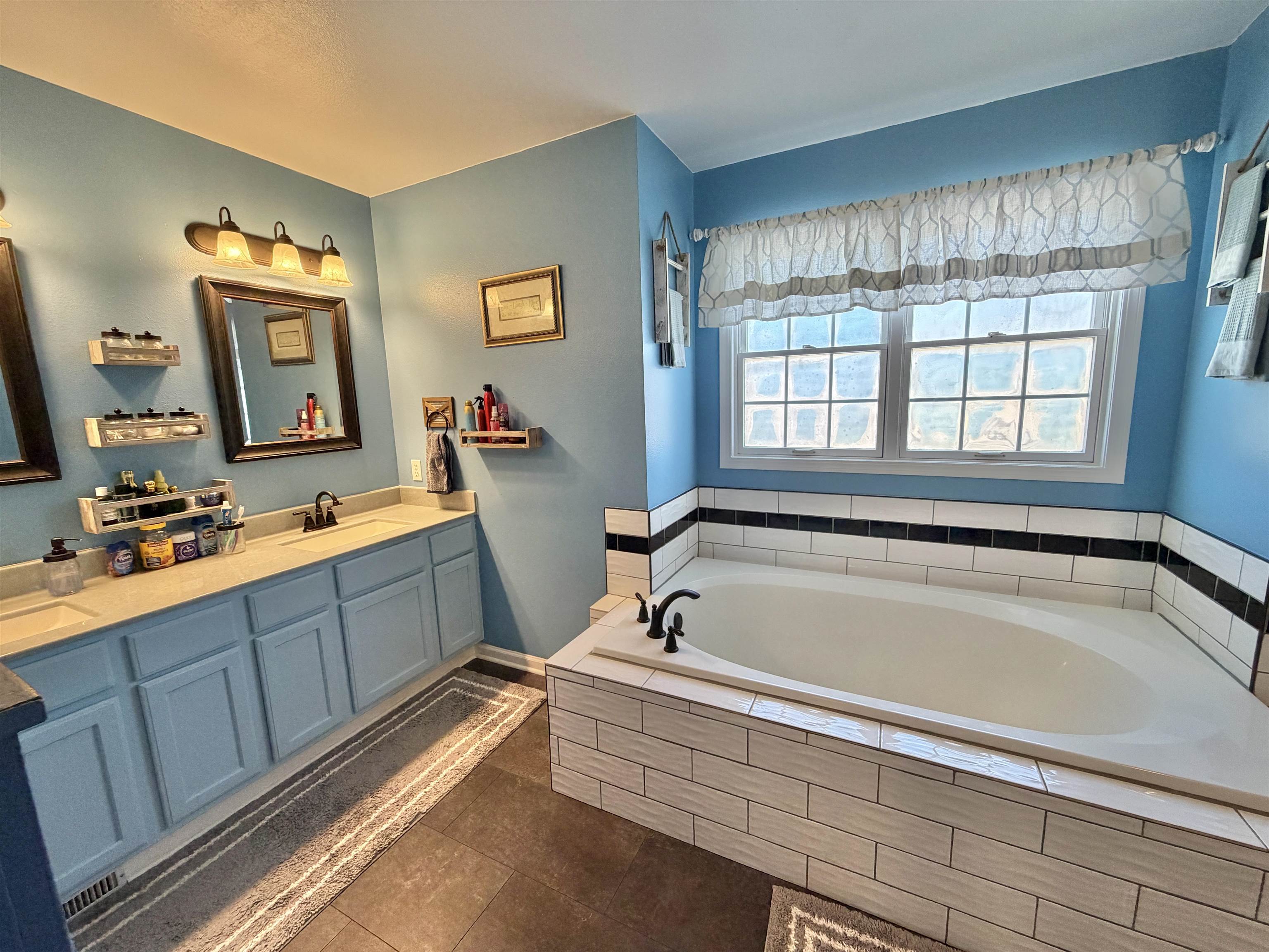 5206 East Hubbard Trail Byron, IL 61010 - Photo 35 of 52 a spacious bathroom with sink and mirror with bathtub