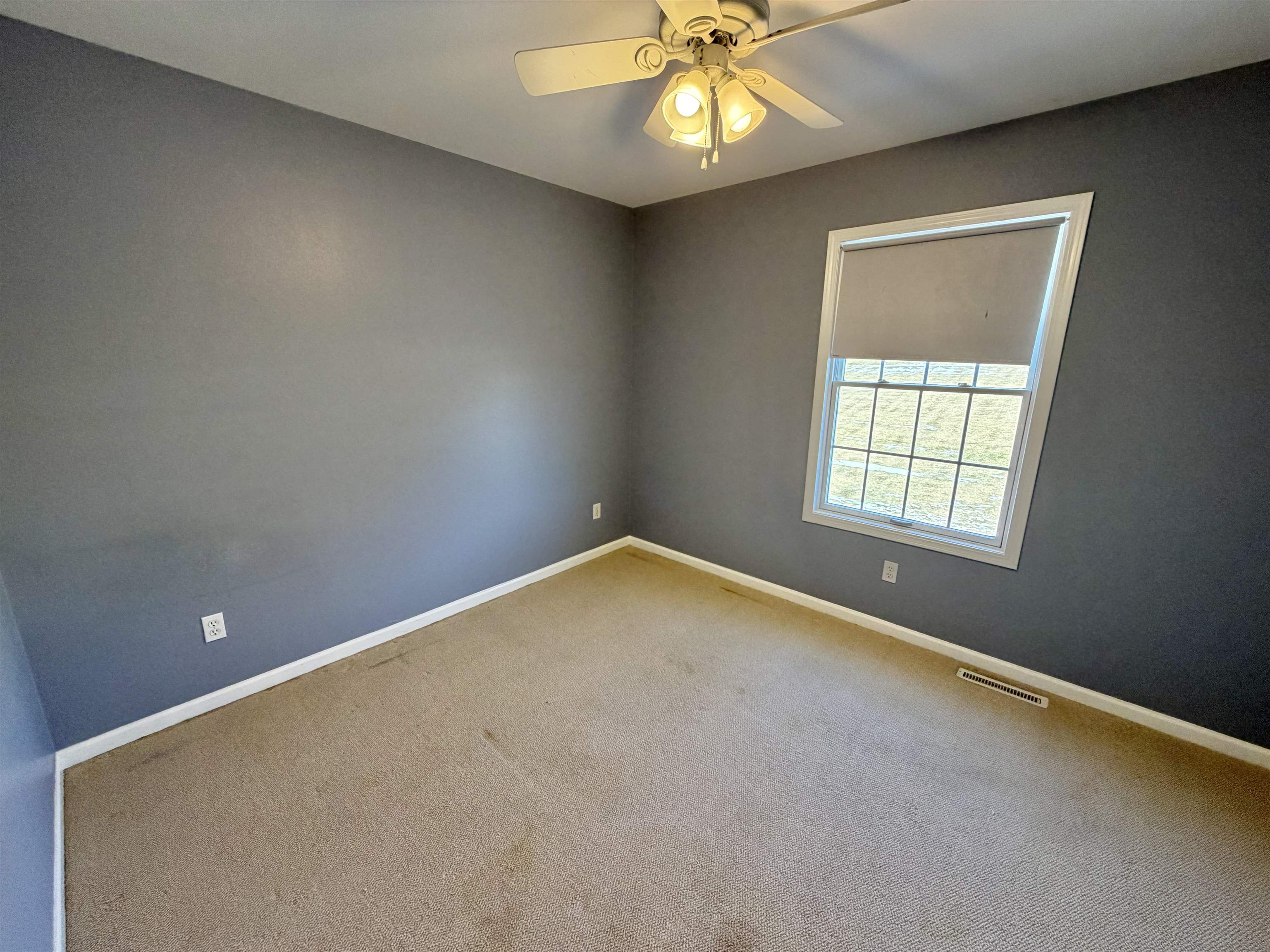 5206 East Hubbard Trail Byron, IL 61010 - Photo 50 of 52 an empty room with a chandelier fan and windows