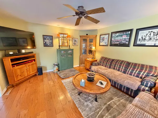 a kitchen with a table chairs and wooden floor