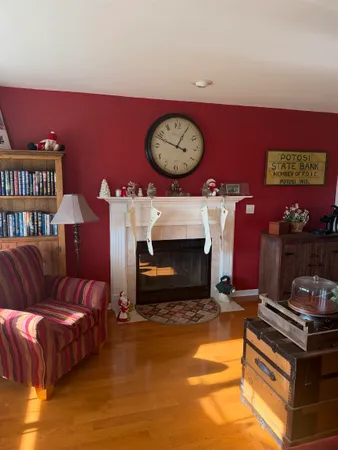 a view of empty room with window and wooden floor