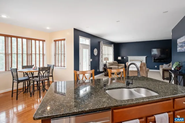 a kitchen with center island table and chairs