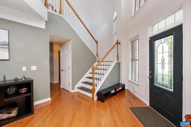 a view of entryway with wooden floor and stairs