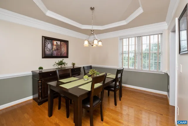 a view of a dining room with furniture and chandelier