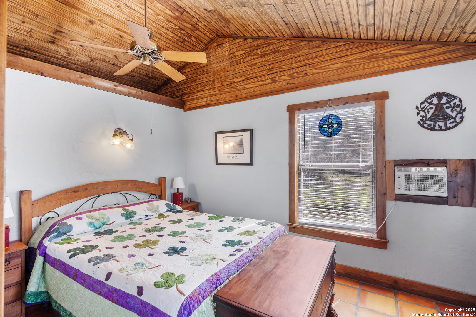 2925 County Road 361 Utopia, TX 78884 - Photo 14 of 35 a bedroom with a bed and a window