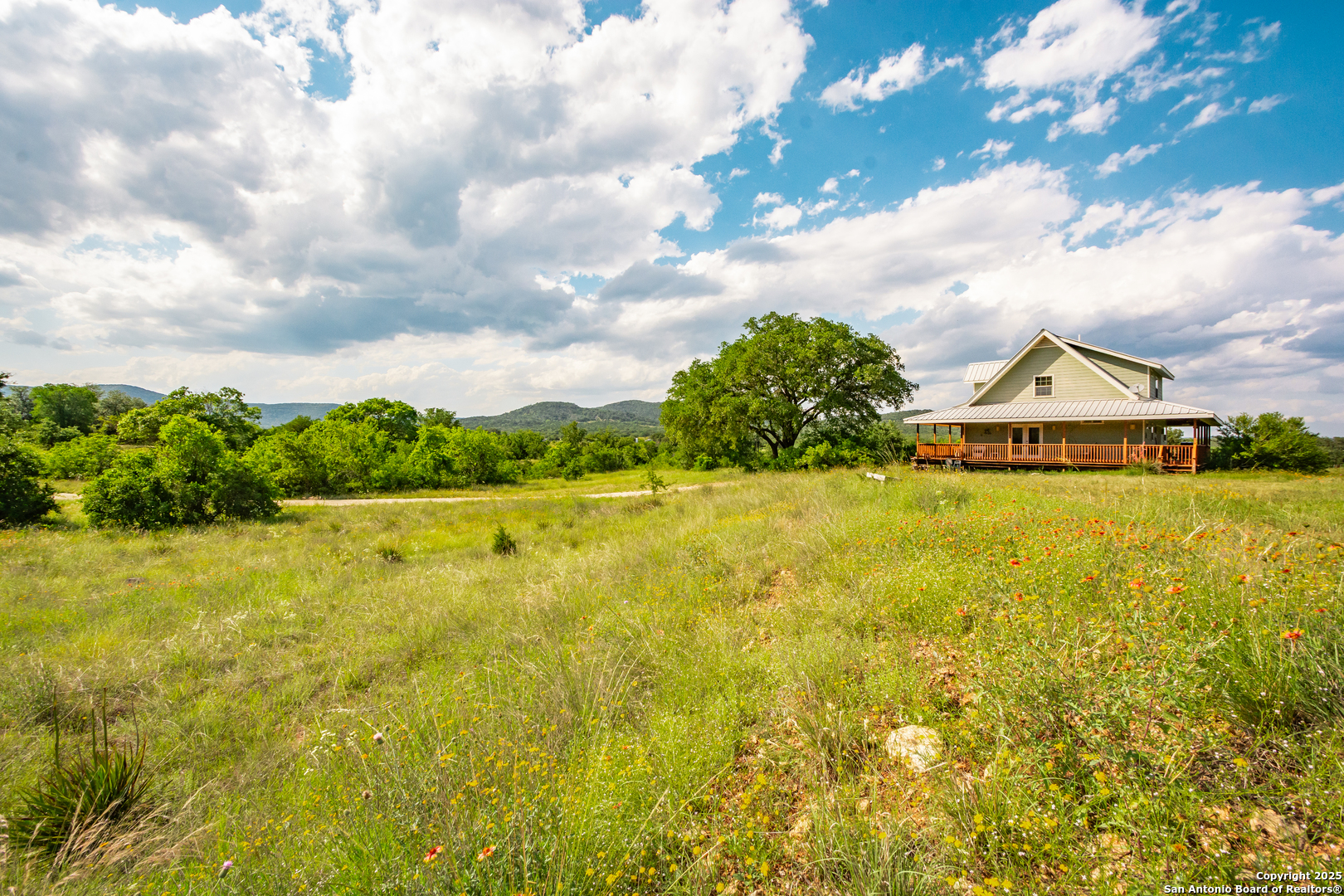 2925 County Road 361 Utopia, TX 78884 - Photo 19 of 35 a view of a large body of water with a house in the background