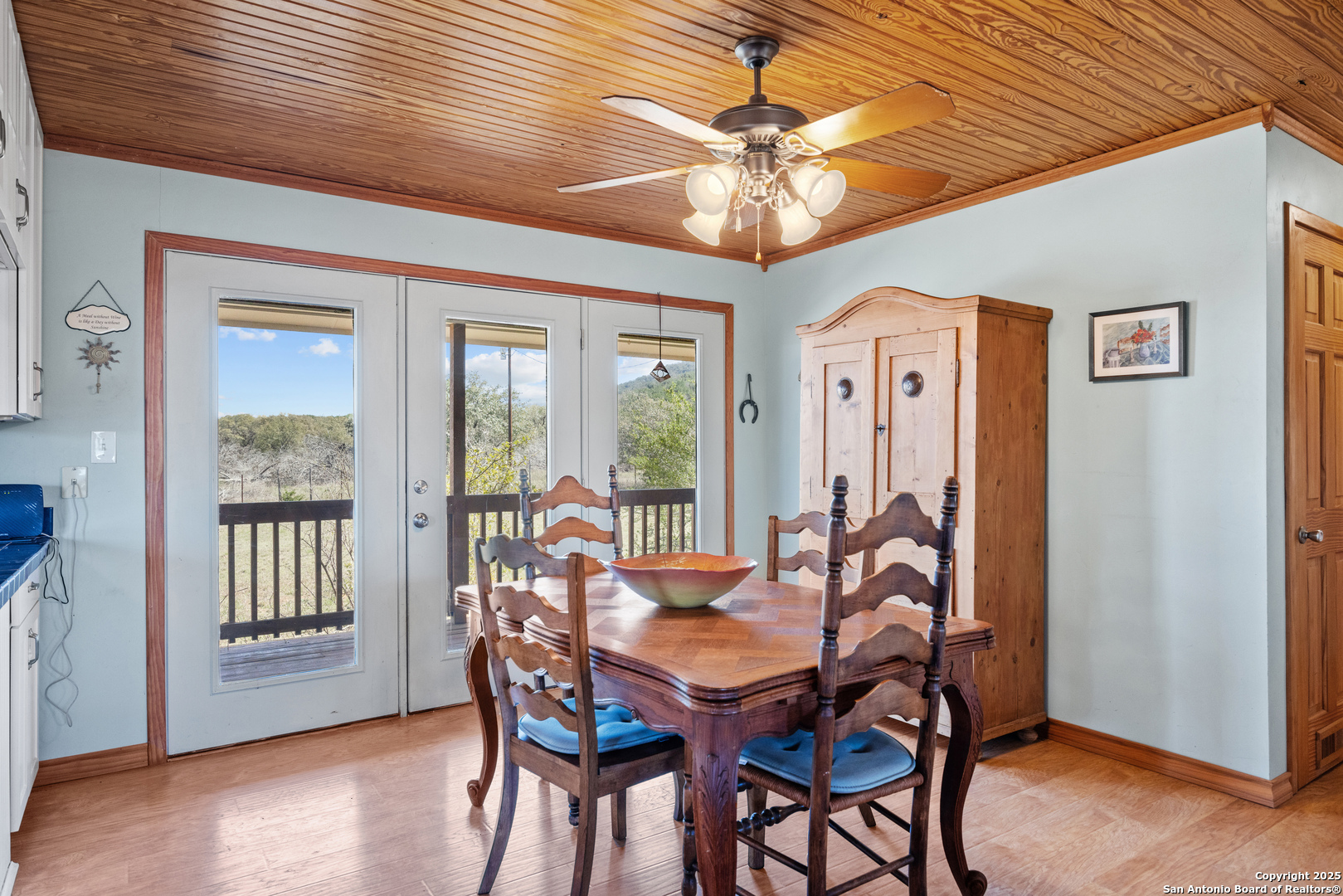 2925 County Road 361 Utopia, TX 78884 - Photo 6 of 35 a view of a dining room with furniture wooden floor and chandelier