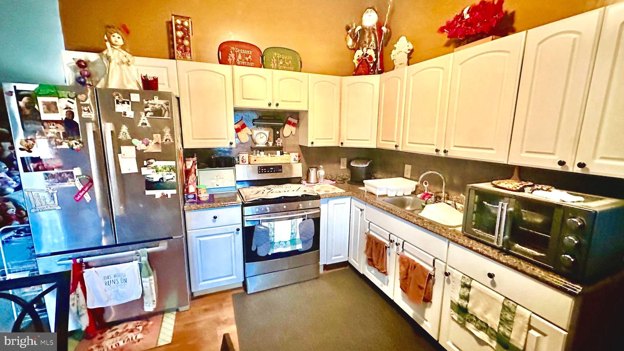 69 High Street Leesburg, NJ 08327 - Photo 17 of 34 a kitchen with stainless steel appliances granite countertop a stove a sink and a refrigerator