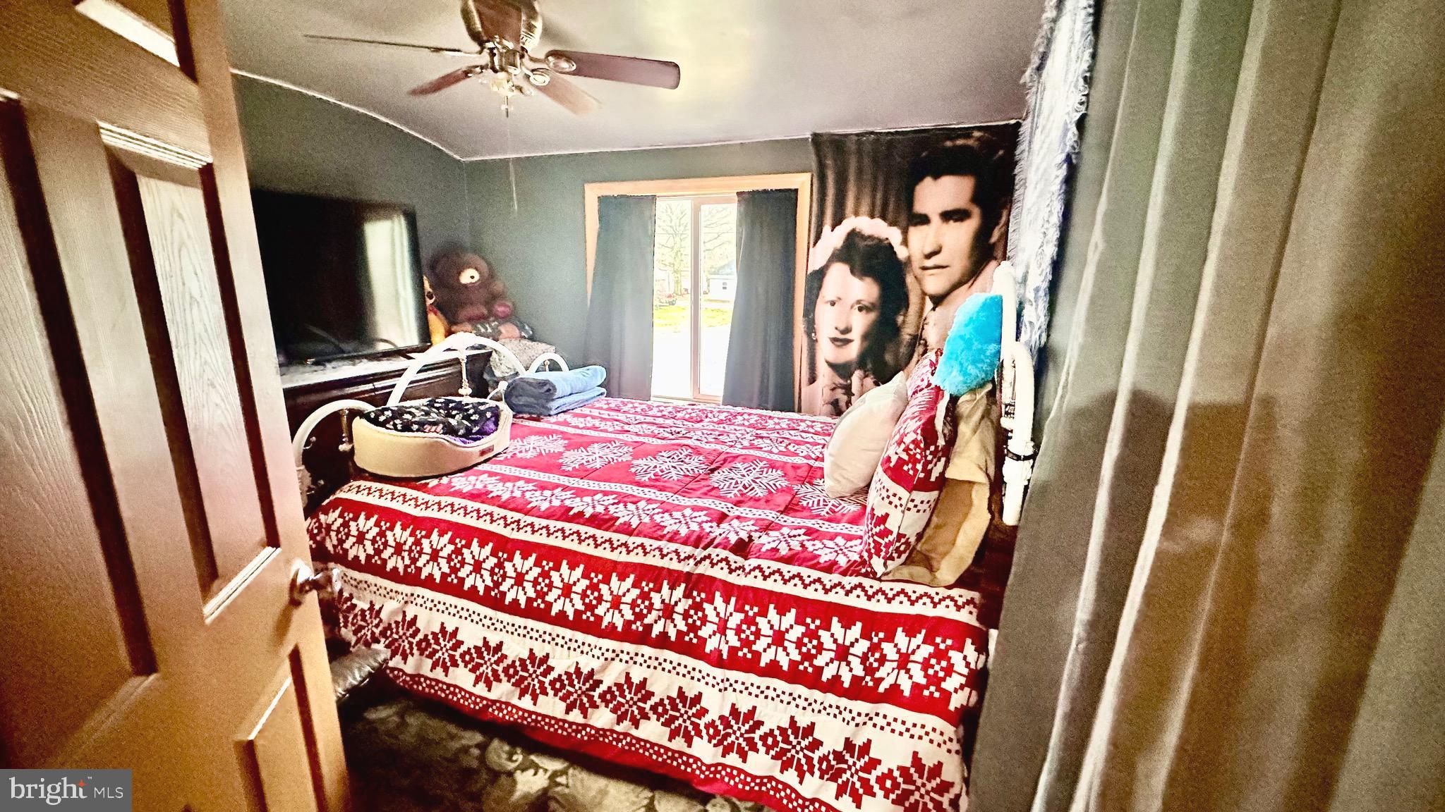 69 High Street Leesburg, NJ 08327 - Photo 22 of 34 a bedroom with a bed and a flat tv screen on dresser